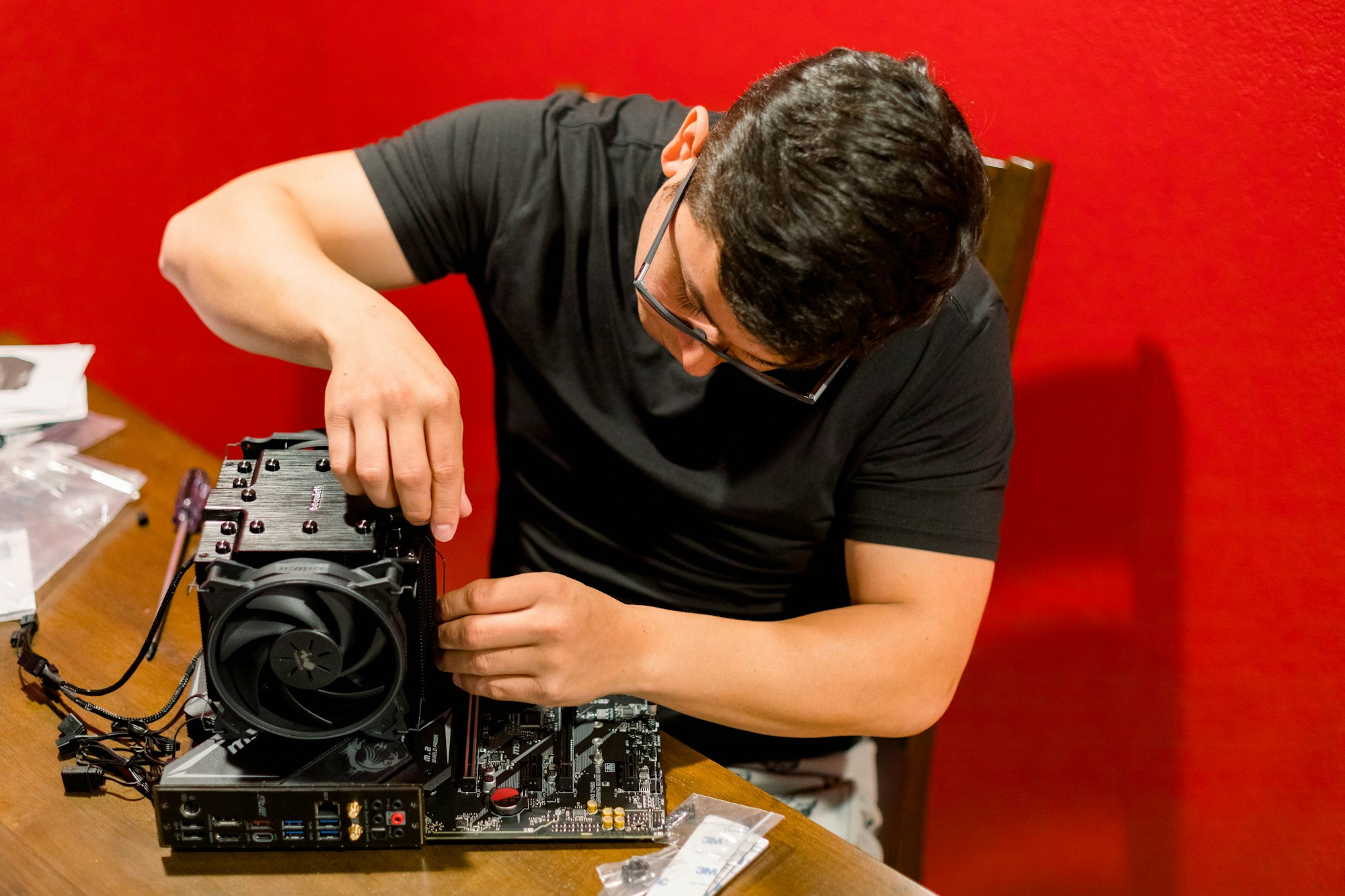 Young Hispanic man building a pc